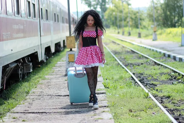 face, train, waiting, suitcase, platform, dress, dots, red, luggage, train, train, suitcase, luggage, luggage, luggage, luggage, luggage. Two-bag packing for a U.S. rail weekend