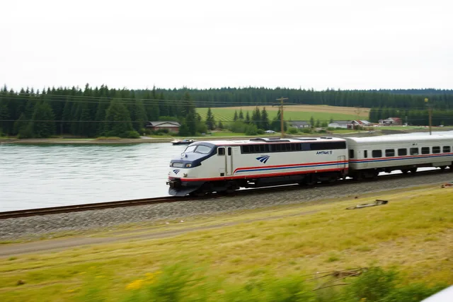 Amtrak Cascades train running north along Puget Sound shoreline. Amtrak Cascades from Seattle or Portland to Vancouver, BC